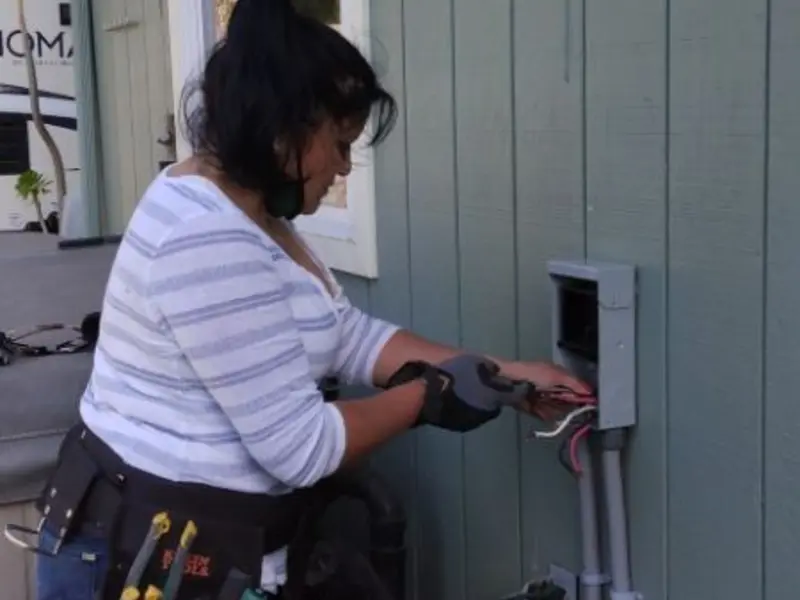 Licensed electrician wiring an exterior subpanel in Hooksett